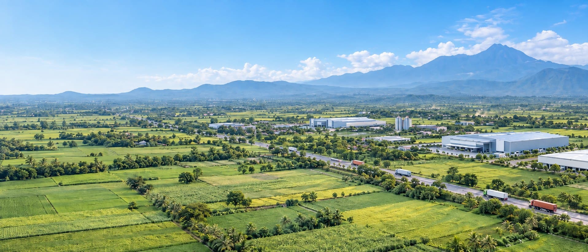 Aerial view of SAA Group industrial facilities surrounded by farmland and mountains in Indonesia